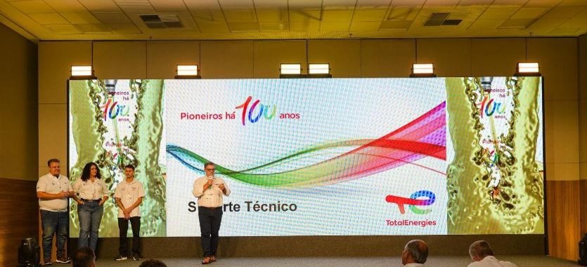 Apresentação no palco com painel da Total Energies
